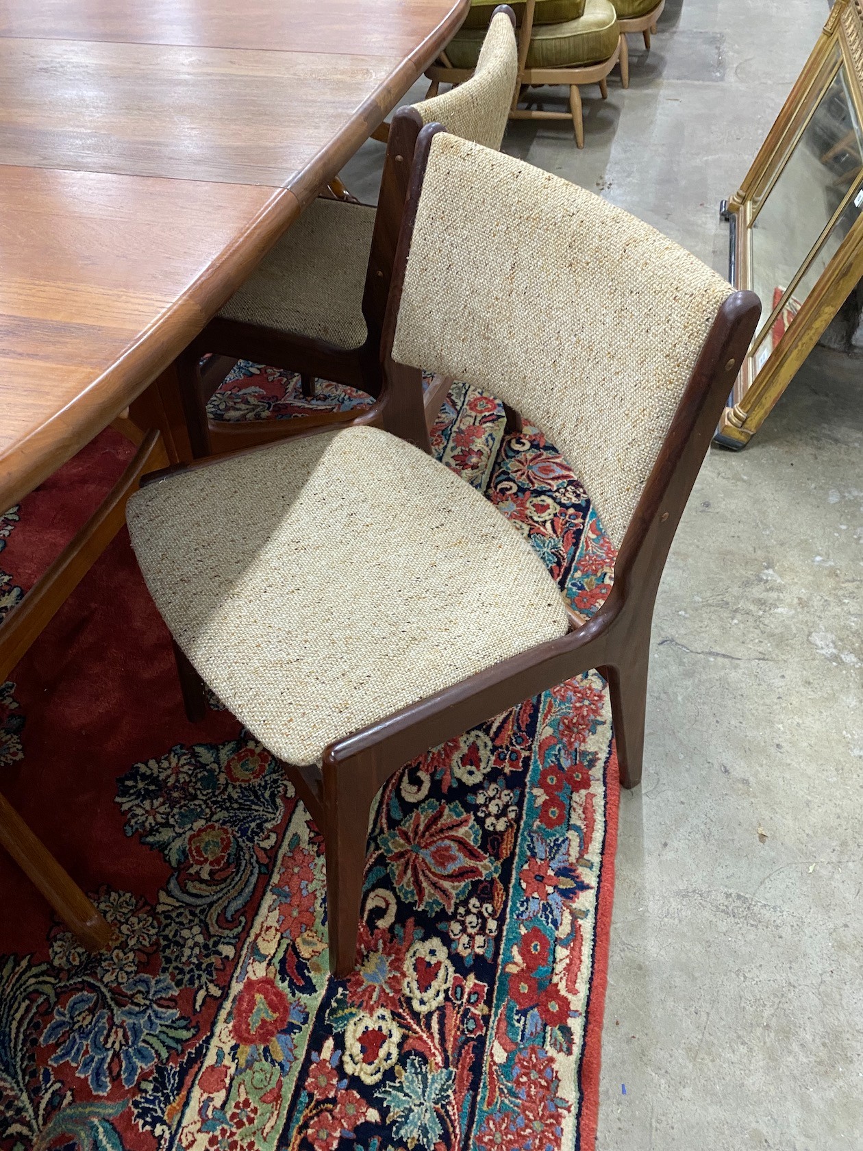 A mid century teak extending dining table, length 214cm extended, one spare leaf, width 108cm, height 75cm together with four teak dining chairs and two elbow chairs